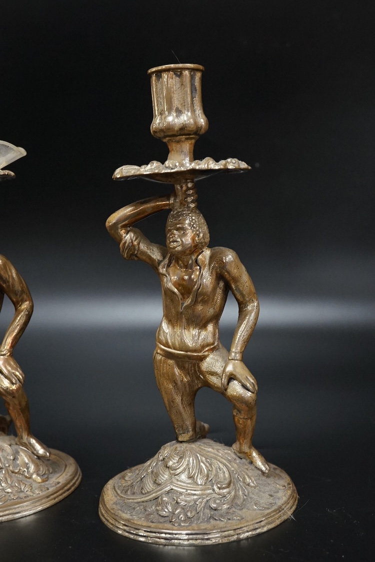 A pair of Blackamoor silvered brass candlesticks, 19cm high